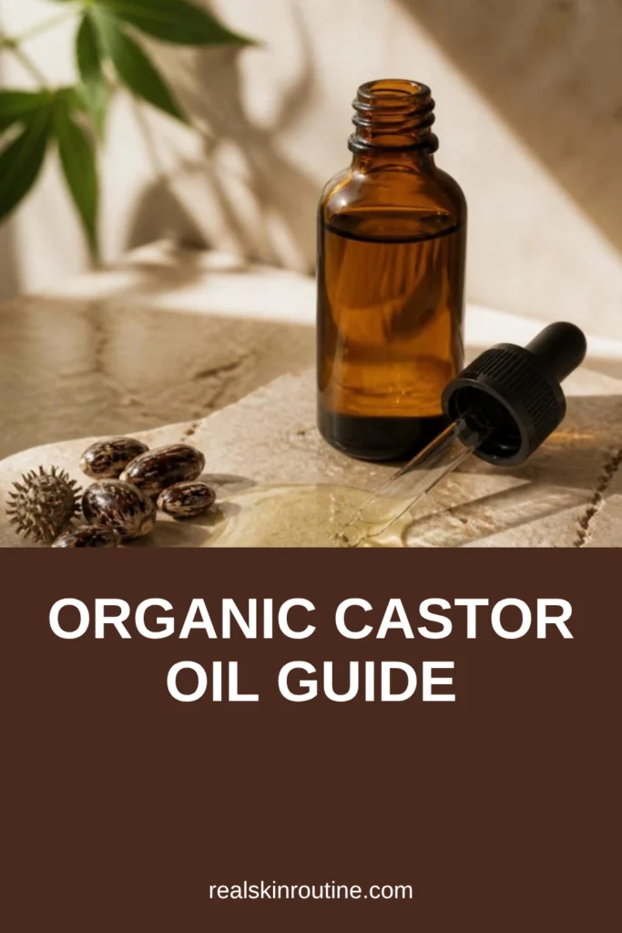 Amber glass dropper bottle and a pool of golden oil on beige stone, pin for organic castor oil