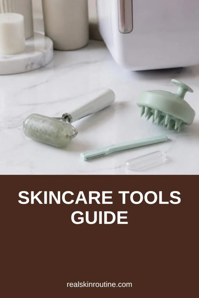 Ice roller, facial razor and scalp massager on a marble vanity, pin for skincare tools