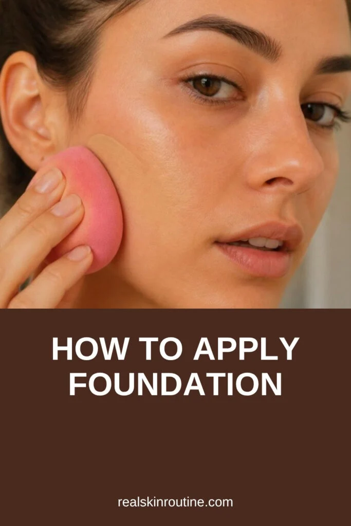Woman blending liquid foundation with a damp makeup sponge, pin for how to apply foundation